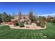 Beautifully landscaped backyard with desert plants, lawn, and cozy seating area at 4680 Suntree Ct, Pahrump, NV 89061