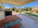Outdoor dining area with a picnic table and a view of the landscaped yard with a shed at 4680 Suntree Ct, Pahrump, NV 89061