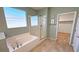 Bright bathroom featuring a soaking tub and glass enclosed shower at 4680 Suntree Ct, Pahrump, NV 89061