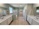 Bathroom featuring double sinks, tile flooring, a walk-in shower and large mirrors at 4680 Suntree Ct, Pahrump, NV 89061