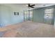 Spacious bedroom featuring light walls, two bright windows, and a ceiling fan at 4680 Suntree Ct, Pahrump, NV 89061