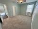 Spacious carpeted bedroom with neutral walls, ceiling fan, and windows at 4680 Suntree Ct, Pahrump, NV 89061