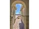 Arched entry to home shows brick pavers and desert landscaping at 4680 Suntree Ct, Pahrump, NV 89061