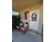 Front porch with cozy chairs and a welcome mat, creating a relaxing ambiance at 4680 Suntree Ct, Pahrump, NV 89061