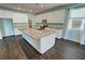 Spacious kitchen boasts white cabinetry, granite counters, stainless steel appliances, and hardwood flooring at 4680 Suntree Ct, Pahrump, NV 89061