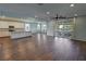 Open-concept living area with a modern kitchen, plenty of natural light, and wood-look floors at 4680 Suntree Ct, Pahrump, NV 89061