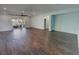 Open living room with dark wood flooring and sliding glass doors to outdoor patio at 4680 Suntree Ct, Pahrump, NV 89061