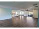 Large living room with wood-style flooring, open to a kitchen and backyard patio at 4680 Suntree Ct, Pahrump, NV 89061