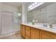 Bathroom with a double sink vanity and glass-enclosed shower at 50 Aura De Blanco St # 19203, Henderson, NV 89074