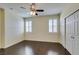 Bedroom with wood floors, ceiling fan, and double closets at 50 Aura De Blanco St # 19203, Henderson, NV 89074