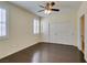 Bedroom with wood floors, shutters, and a double door closet at 50 Aura De Blanco St # 19203, Henderson, NV 89074