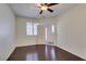 Bright bedroom with wood floors, ceiling fan, and plantation shutters on the windows at 50 Aura De Blanco St # 19203, Henderson, NV 89074
