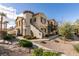 Charming townhome with unique architectural details, including a turret and landscaped front yard at 50 Aura De Blanco St # 19203, Henderson, NV 89074