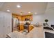 Kitchen features stainless appliances, tile floors, and breakfast bar at 50 Aura De Blanco St # 19203, Henderson, NV 89074