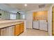 Open kitchen view with laundry area and access to living room at 50 Aura De Blanco St # 19203, Henderson, NV 89074