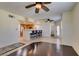 Spacious living room with hardwood floors, ceiling fans, and a breakfast bar connecting to the kitchen at 50 Aura De Blanco St # 19203, Henderson, NV 89074