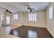 Spacious living room with natural light, modern ceiling fan, and elegant hardwood flooring at 50 Aura De Blanco St # 19203, Henderson, NV 89074