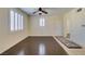 Inviting living room featuring hardwood floors, plantation shutters and a ceiling fan at 50 Aura De Blanco St # 19203, Henderson, NV 89074