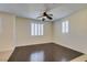 Inviting living room featuring a ceiling fan, plantation shutters, and modern, dark hardwood flooring at 50 Aura De Blanco St # 19203, Henderson, NV 89074