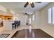 Bright living space with hardwood floors, kitchen access, ceiling fans, and a door to the outside at 50 Aura De Blanco St # 19203, Henderson, NV 89074