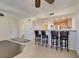 Open living area with breakfast bar, tile floors, and a ceiling fan at 50 Aura De Blanco St # 19203, Henderson, NV 89074