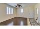 Cozy living room with plantation shutters, ceiling fan, and stylish flooring at 50 Aura De Blanco St # 19203, Henderson, NV 89074