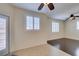 Light-filled living room featuring hardwood floors, plantation shutters, and a seamless transition to outdoor patio at 50 Aura De Blanco St # 19203, Henderson, NV 89074