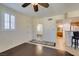 Inviting living area featuring hardwood floors, plantation shutters, and seamless flow into kitchen, perfect for modern living at 50 Aura De Blanco St # 19203, Henderson, NV 89074