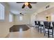 The inviting living area features hardwood floors and a seamless flow to the kitchen's breakfast bar at 50 Aura De Blanco St # 19203, Henderson, NV 89074