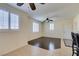 Hardwood living room with plantation shutters, neutral walls, and direct access to the breakfast bar with seating at 50 Aura De Blanco St # 19203, Henderson, NV 89074