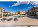 Community pool with lounge chairs and covered seating area for relaxing on sunny days at 50 Aura De Blanco St # 19203, Henderson, NV 89074