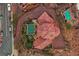 Aerial view of estate home showing geometric roof, infinity pool and lush landscaped backyard oasis at 503 Aaron Way, Boulder City, NV 89005