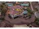 Stunning aerial view showcasing a custom home with unique roof and hardscape on a desert hillside at 503 Aaron Way, Boulder City, NV 89005