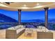 Inviting covered balcony featuring comfortable seating and breathtaking mountain and lake views at 503 Aaron Way, Boulder City, NV 89005