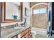 Elegant bathroom features granite counters, wooden cabinets, and a tile shower/tub combination at 503 Aaron Way, Boulder City, NV 89005