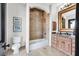 Well-lit bathroom features a shower over tub, a toilet, and vanity with marble counters at 503 Aaron Way, Boulder City, NV 89005