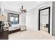 Bright bedroom with a sliding glass door, ceiling fan, and attached bathroom at 503 Aaron Way, Boulder City, NV 89005
