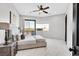 Bright bedroom with floor-to-ceiling windows, ceiling fan, and balcony access at 503 Aaron Way, Boulder City, NV 89005