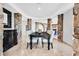 Formal dining room with statement stone columns, arched entryways, and black dining set at 503 Aaron Way, Boulder City, NV 89005