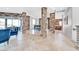 Elegant dining area featuring travertine floors, stone columns, and seamless access to the living area at 503 Aaron Way, Boulder City, NV 89005