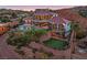Multi-level home features a sparkling pool, manicured landscaping, and striking architectural design at 503 Aaron Way, Boulder City, NV 89005
