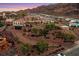 Stunning hillside home with tile roof, balconies, lush landscaping, and an in-ground pool overlooking desert mountains at 503 Aaron Way, Boulder City, NV 89005