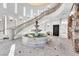 Grand foyer with high ceilings, elegant staircase, stone accents, a fountain, and unique tile flooring at 503 Aaron Way, Boulder City, NV 89005