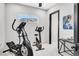 Home gym area with stationary bike, elliptical machine, and outside views at 503 Aaron Way, Boulder City, NV 89005