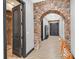 Beautiful hallway with stone archway, neutral paint, and interesting tiger statue at 503 Aaron Way, Boulder City, NV 89005