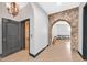 Striking hallway with stone archway, wood flooring, and elevator access at 503 Aaron Way, Boulder City, NV 89005