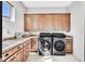Laundry room boasts granite countertops, cabinetry, sink, and tile flooring at 503 Aaron Way, Boulder City, NV 89005