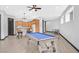 Spacious living room with a pool table, dining area and an open concept kitchen with wood cabinets at 503 Aaron Way, Boulder City, NV 89005
