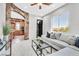 Inviting living room with stone archway and a view into a modern kitchen and scenic landscape at 503 Aaron Way, Boulder City, NV 89005