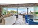 Open living room with stone accents, sliding glass doors to the patio, and breathtaking views of the mountains and lake at 503 Aaron Way, Boulder City, NV 89005